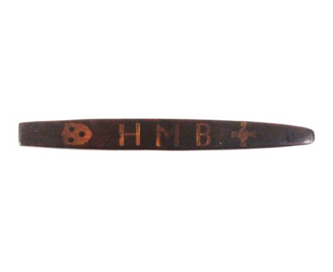 A mahogany knitting stick, of slightly curved boat shaped form, one side inlaid in pale wood with the initials 'HMB' between 