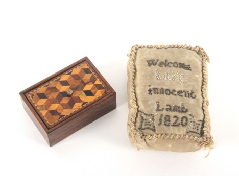 A layette pin cushion, 1820, and a Tunbridge ware box, the rectangular pin cushion inscribed in pins 'Welcome Little Innocent