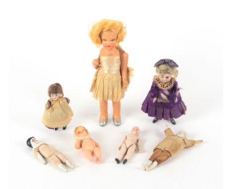 Seven small dolls, 19th Century and later, comprising five with ceramic elements, two clothed, largest 11cms, and two composi