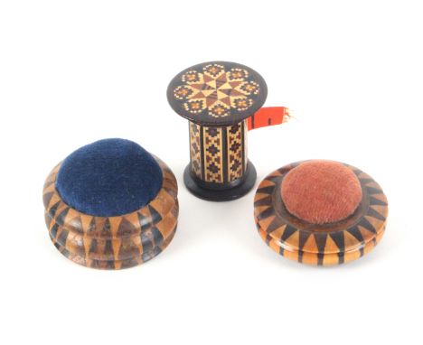 Tunbridge ware - three pieces, comprising two circular stick ware pin cushions, one raised on three bun feet, 4.2 and 4.3cms,