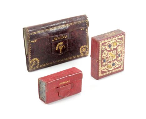 Three leather needle packet cases, comprising a red leather book form example with gilt tooled spine and titled 'Needles', in