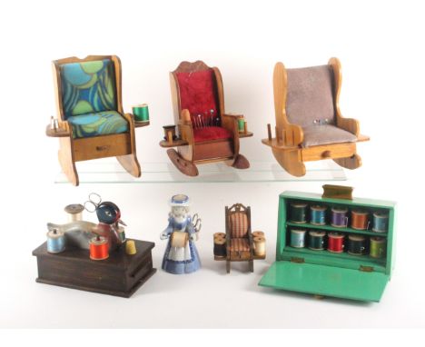 A selection of 20th Century novelty reel stands, comprising a rectangular drawer base example surmounted by a painted figure 