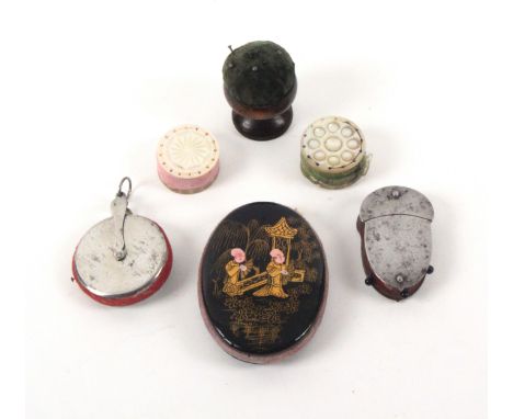 Four pin cushions and two emeries, comprising an oval papier mache pin cushion, one side in chinoiserie lacquer of two men in