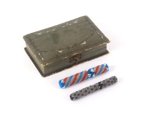 Two beadwork cylinder needle cases and a sewing companion, one needle case brightly decorated with a spiral pattern, wooden c