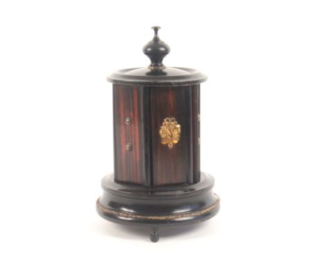 An unusual French musical box sewing companion, circa 1880, the turned and ebonised gilt mounted circular base raised on thre