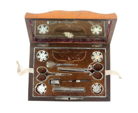 A satinwood Palais Royal sewing box circa 1830, the bombe sides below an undulating top centred by a steel carrying handle wi