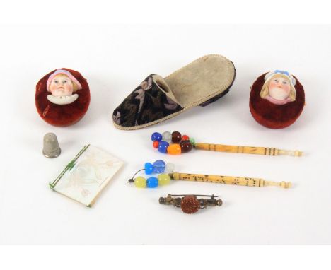 A mixed lot - sewing, comprising a pair of velvet and silk oval pin cushions each mounted with a ceramic face of a child, mot