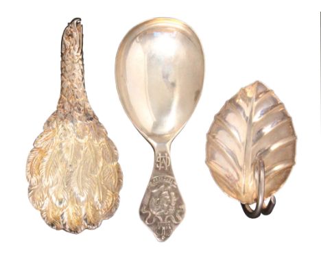 Three caddy spoons, comprising a silver example, the handle commemorating the silver jubilee of George V and Queen Mary, Shef