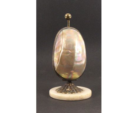 A mother of pearl egg form etui, circa 1870, the circular alabaster base with gilt mount, the egg opening by depressing the b