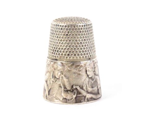 An early 20th Century French thimble, the frieze depicting an elderly man and woman seated at a table, a dog looking on, and 