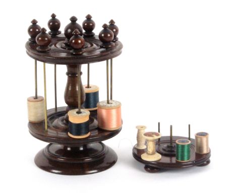 Two wooden reel stands, comprising a two tier example on turned circular base to a baluster form stem with turned finial, the