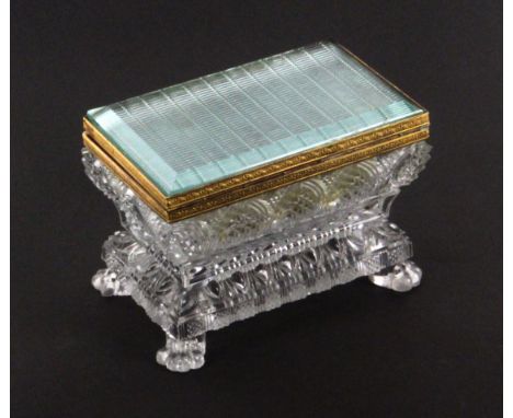 A French glass and gilt metal mounted casket, circa 1830, of bombe form raised on lion paw feet, gilt brass lock and floral b