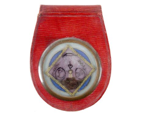 An attractive Georgian red leather purse, of sporran form, one side with glazed circular panel enclosing a verre eglomise and