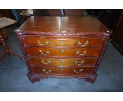 A Chippendale style hardwood serpentine commode 