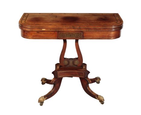 A REGENCY BRASS-INLAID ROSEWOOD CARD-TABLE Early 19th century, the rounded rectangular swivelling top enclosing a green baize