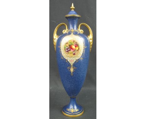 ROYAL WORCESTER PORCELAIN TWIN HANDLED VASE AND COVER having hand painted reserve panel of fruit on a mossy background, signe