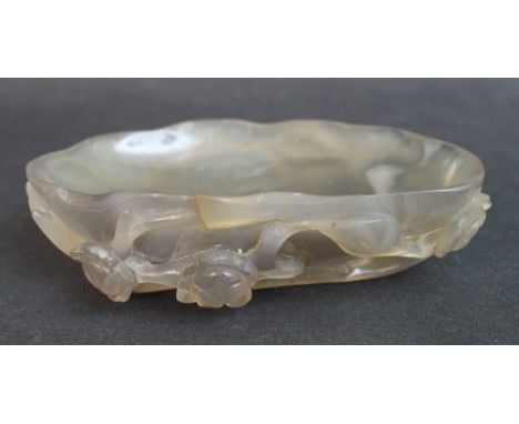 WELL CARVED CHINESE HARDSTONE DISH IN THE FORM OF A LOTUS LEAF,  having detailed veins and carved externally with trailing br