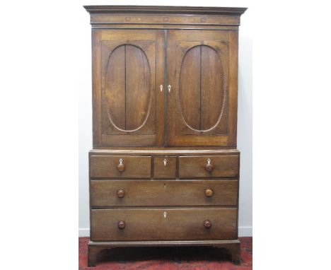 EARLY 19TH CENTURY WELSH OAK, TWO STAGE PRESS CUPBOARD, having fluted, moulded cornice over a pair of oval, panelled doors re