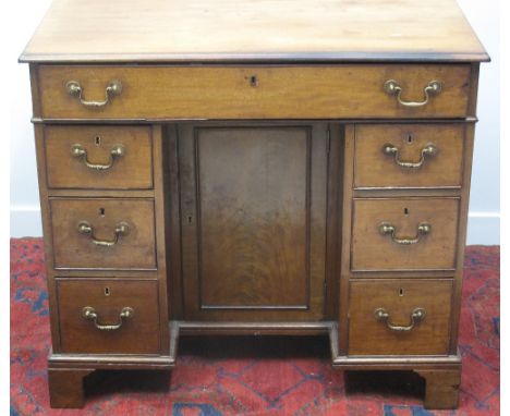 18TH CENTURY MAHOGANY KNEEHOLE DESK OR DRESSING TABLE, having moulded edged top over frieze drawer opening to reveal brushing