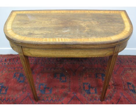 REGENCY ROSEWOOD DEMI LUNE FOLD OVER CARD TABLE, the top with broad satinwood banding and ebony stringing, revealing green ba