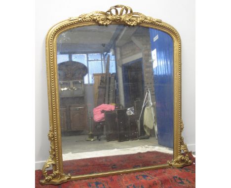 19TH CENTURY GILT FRAMED, ARCHED, OVER MANTEL MIRROR, having ribboned cresting and beaded frame, foliate scrolled angles to t
