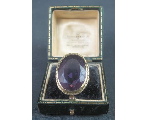 LARGE GOLD SET AMETHYST STONE BISHOP'S RING, having pierced foliate mount and foliate shoulders. Unmarked. The stone 23mm app