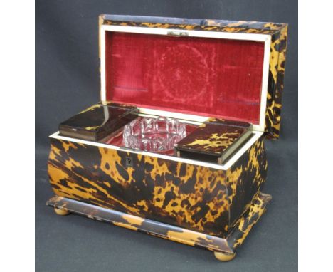 19TH CENTURY LARGE SARCOPHAGUS SHAPED TEA CADDY raised on four bun feet, having fitted interior and central glass mixing bowl