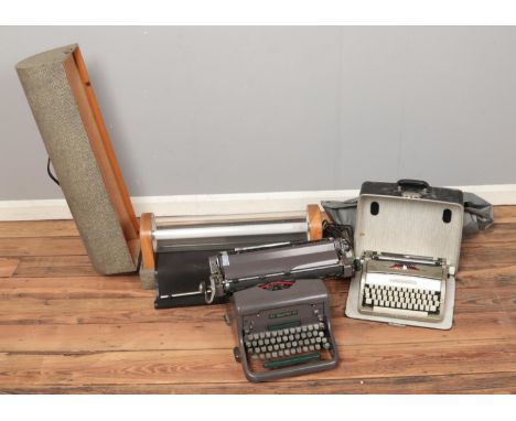 Two cased typewriters, including Imperial No. 66, together with a large cased cylindrical light.  
