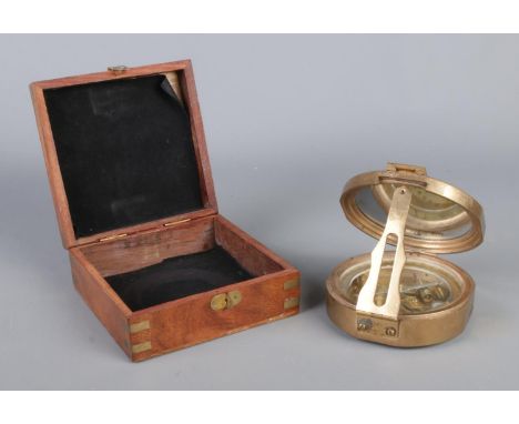 A cased nautical brass compass, with 'Natural Sine' figures to the front and anchor inlaid in case.  