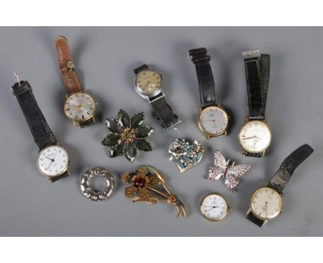 A collection of watches and costume jewellery brooches. Includes manual watches.  