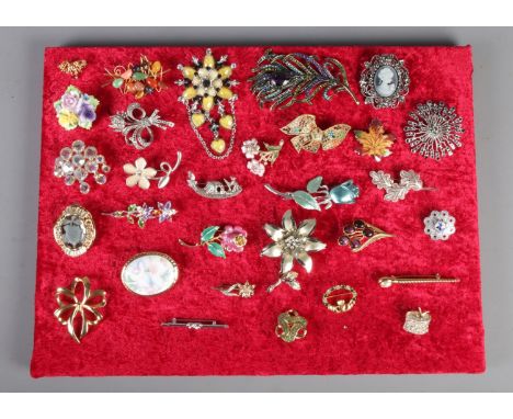 A quantity of costume brooches. Including silver leaf example, coloured paste stone examples, etc. Approximately 30.  