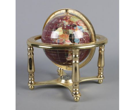 A modern gemstone globe on stand, with compass built into the base. Height: 24cm.  