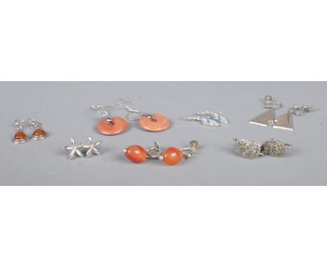 Seven pairs of silver earrings, to include marcasite and floral examples.  