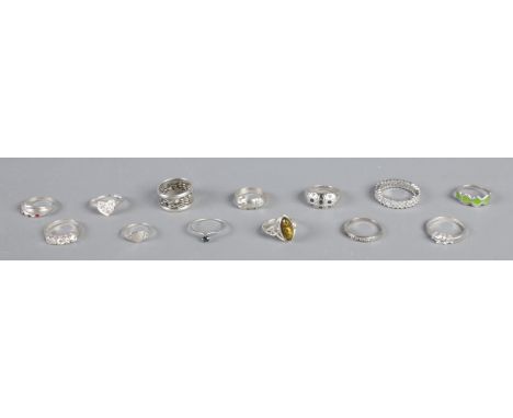Thirteen silver rings, including belt buckle, Cubic Zirconia and heart-shaped examples. All stamped 925. Total weight: 31.2g 