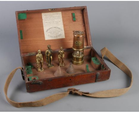 A John Davis & Son wooden box with contents of mining collectables. Includes Welsh Davy lamp, brass miner figures etc.  