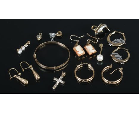 A quantity of 9ct Gold and yellow metal jewellery. To include 9ct dolphin hoop earrings and pendant, cameo earrings, crucifix