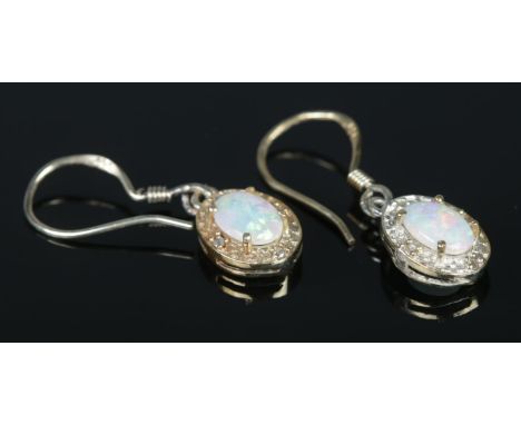 A pair of silver gilt, opal and diamond set drop earrings. Stamped to hoop.  