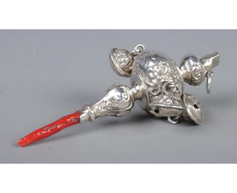 A Victorian rattle and whistle, with repousse decoration and coral handle. Tests as silver.  