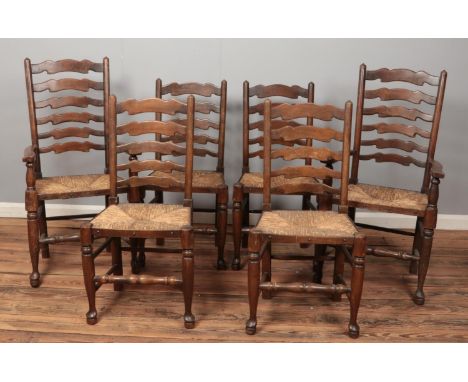 A set of six ladder back dining chairs with rush seats.  