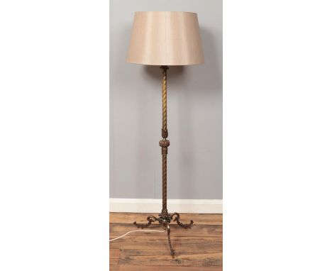 A gilt metal standard lamp, with twisted central column supported by three cabriole feet. Height (including shade): 127cm.  I