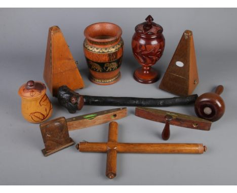 A quantity of woodenware. Including metronomes, vases, lidded pots, spirit levels, etc.  