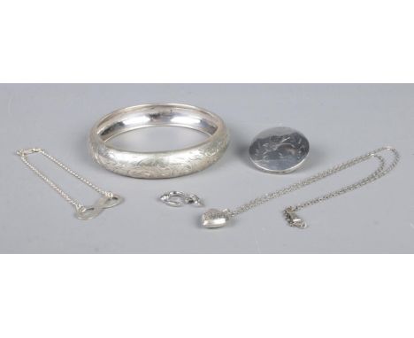 A collection of silver jewellery, including 900 stamped bangle, heart shaped pendant on chain and horseshoe charm. Total weig