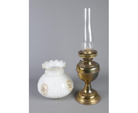 An oil lamp along with floral shade.  