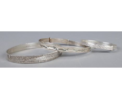 Three silver bangles, including Christening example. One other assayed for Birmingham, 1972. Total weight: 27.6g  
