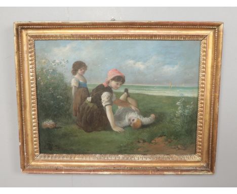 A 19th century gilt framed oil on board depicting three children playing in the grass by a beach. Signed bottom left and date