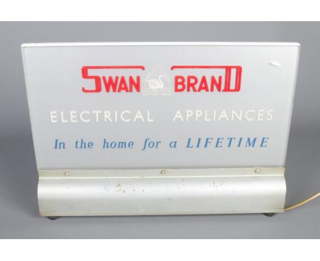 A light up shop window sign for "Swan Brand Electrical Appliances - In the Home for a Lifetime", 26.5cm x 37.5cm.  