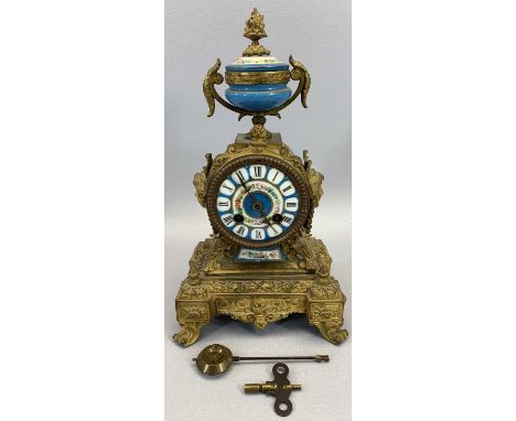 JAPY FRERES CO FRENCH GILT ORMOLU &amp; PORCELAIN MANTEL CLOCK - having an urn finial and side masks to a drum case on steppe