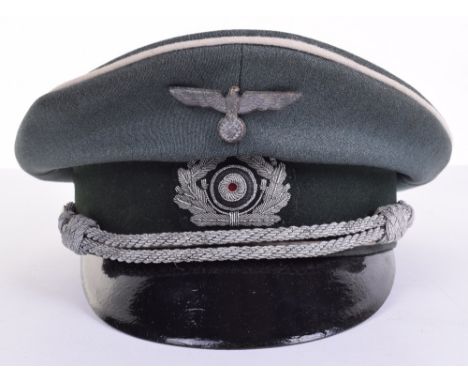 WW2 German Infantry Officers Peaked Cap, of green cloth body with white piping to the crown and bordering the central band. B