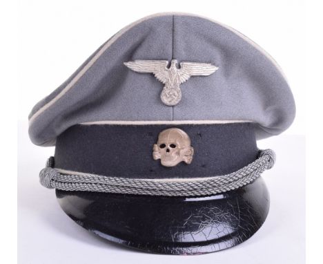 WW2 German Waffen SS Officers Peaked Cap, complete with metal skull and eagle insignia. Officers chin cords and patent peak. 