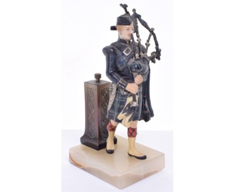 20th Century Table Lighter in the form of a painted Scottish piper standing in front of brass plinth on onyx base. Stands 19 